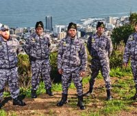 Cobras Protection Team on a mountain with Cape Town CBD in the background