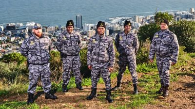 Cobras Protection Team on a mountain with Cape Town CBD in the background