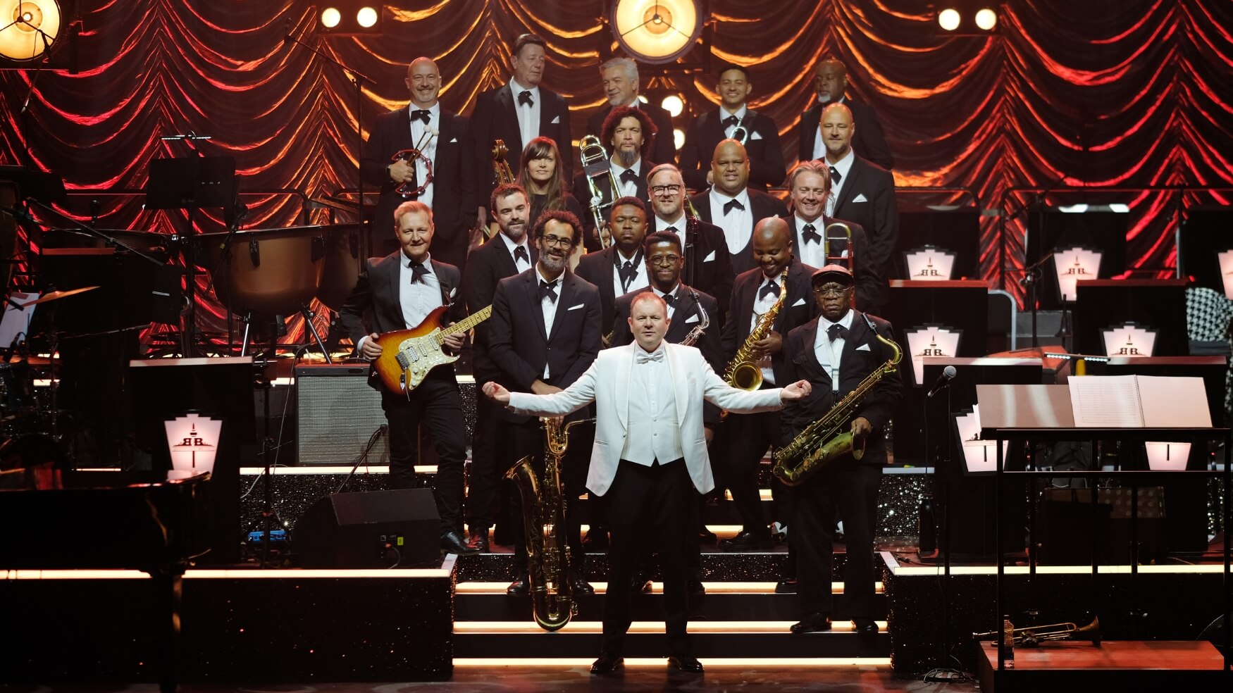 The Johannesburg Big Band posing on stage for Swingin' Las Vegas at The Teatro, Montecasino